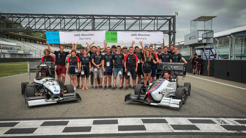 Munich Motorsport team with race cars developed using SLS 3D printed components.